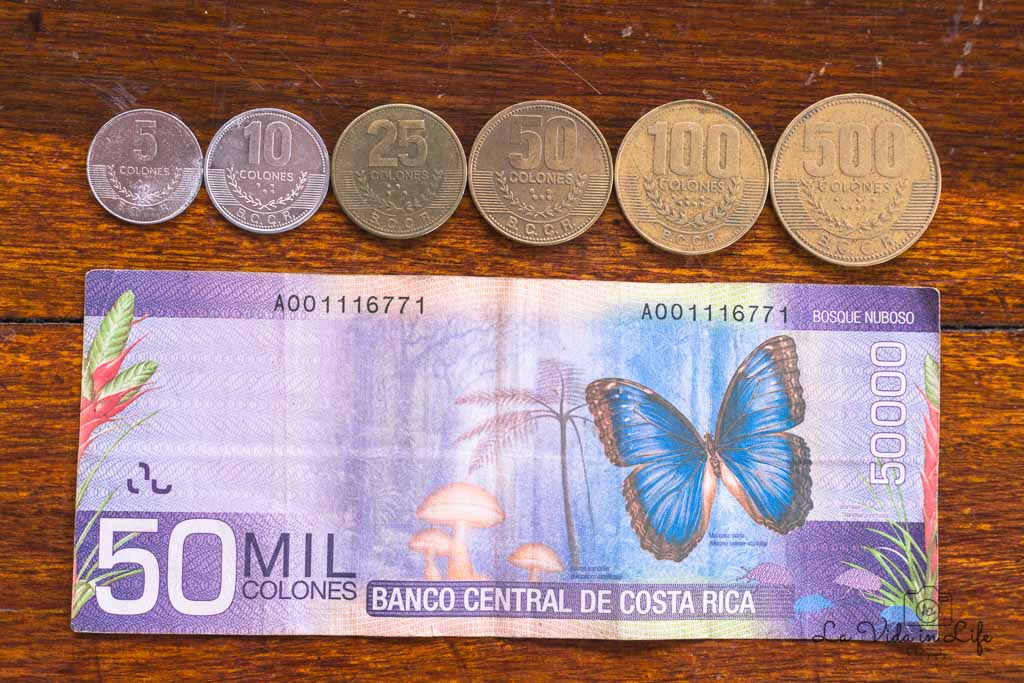 costa rica currency: closeup of 50,000 colones with coins